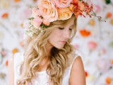 a pink, peachy and orange oversized flower crown with additional blooming branches is a lovely idea for a spring or summer bridal look