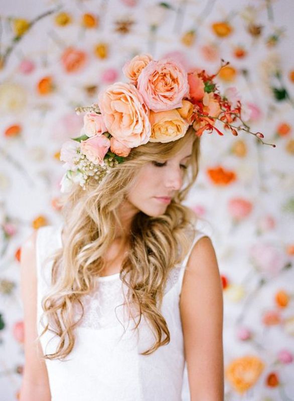A pink, peachy and orange oversized flower crown with additional blooming branches is a lovely idea for a spring or summer bridal look