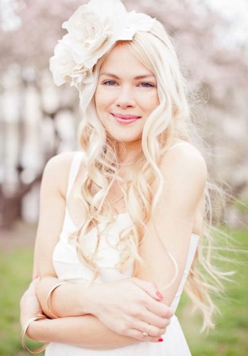 an oversized white fabric flower crown is a gorgeous idea to make a statement with your headpiece and add romance to the look