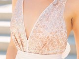a rose gold wedding dress with a shiny bodice with thick straps and a plain flowy skirt is very romantic and beautiful