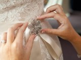 a vintage brooch accenting a wedding sash is a cool accessory and your ‘something old’ at the wedding