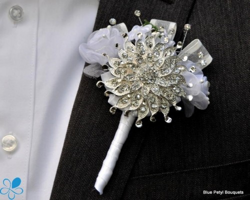 a beautiful vintage brooch wedding boutonniere with ribbons is a chic idea for a vintage groom's look
