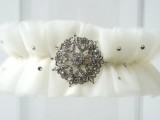 a tulle garter decorated with rhinestones and a vintage brooch is a lovely wedding accessory to rock