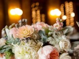 a refined wedding centerpiece of a pink box and a vintage brooch, pink and neutral blooms and greenery is chic