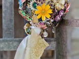 a beautiful and bold vintage brooch wedding bouquet of colorful and bold items and with ribbons is amazing for a wedding