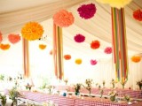 colorful paper pompom garlands over the reception space will make it feel and look more festive