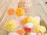 pastel-colored paper pompoms and lights under the dome make the reception space or dance floor fun and bold