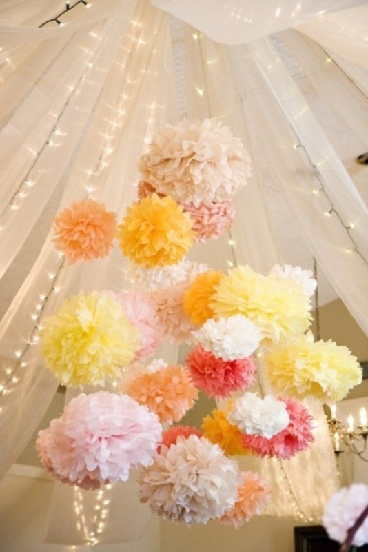 Pastel colored paper pompoms and lights under the dome make the reception space or dance floor fun and bold