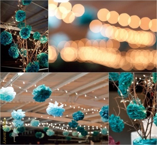 turquoise and teal paper pompoms can be used not only to hang them over the space but also to hang them on branches for a centerpiece