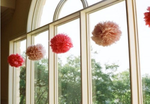 decorate the windows with blush and hot pink paper pompoms hanging on them and make them look fun and bold