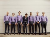 groomsmen wearing lilac shirts and black pants and bow ties to look super cool and chic