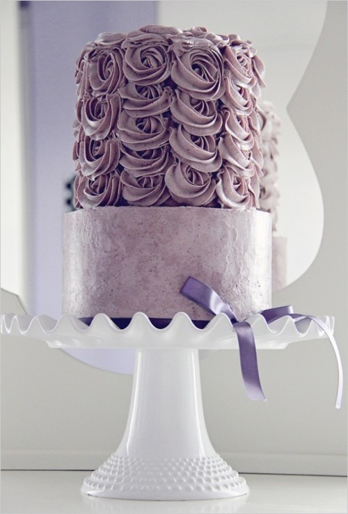 a dusty pink wedding cake with a rose tier and a lilac bow for a romantic wedding