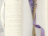 a silver floral print charger, a menu, a napkin and some lavender with lilac ribbon for a chic place setting