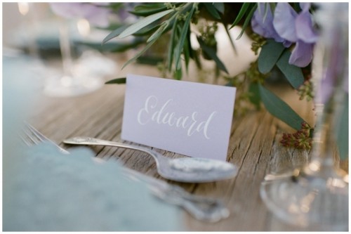 a lavender-colored place card with calligraphy is a chic and stylish idea