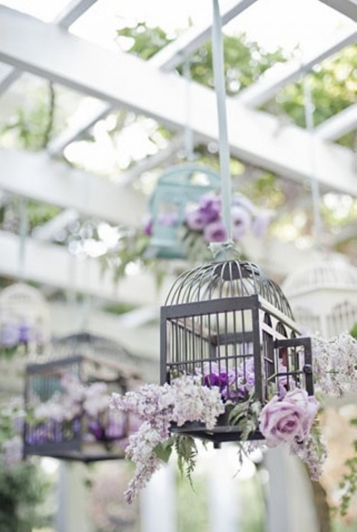 suspended cages with pink and lilac blooms and pale greenery can be amazing for a vintage wedding