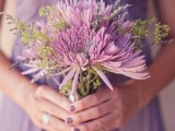 a lilac draped bridesmaid dress and a matching lilac-colored bouquet with greenery