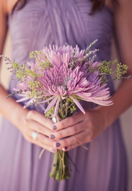 a lilac draped bridesmaid dress and a matching lilac-colored bouquet with greenery