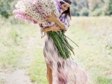 an oversized wedding bouquet done in neutrals and lavender shades for a boho summer bride