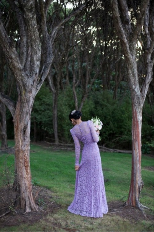 a fitting lilac lace wedding dress with long sleeves, buttons on the back and a high neckline