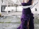 a deep purple one shoulder with a draped bodice and a feather skirt with a train plus white gloves