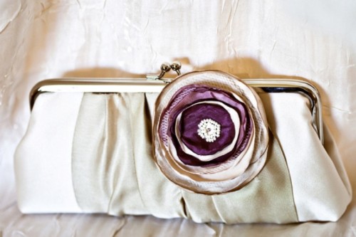 a vintage-inspired silk clutch with a lavender-colored fabric flower for a vintage bride