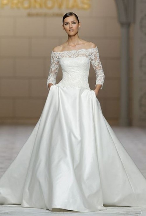 an exquisite formal off the shoulder wedding dress with a lace bodice and a full skirt, plus a long train for a super formal wedding
