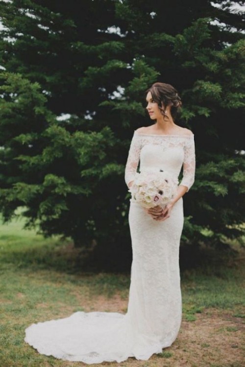 a lace off the shoulder wedding dress with long sleeves and a small train is a beautiful and exquisite solution for a wedding
