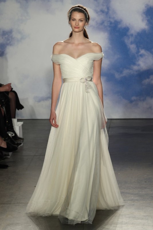 a romantic off the shoulder a line wedding dress with a draped bodice and a tulle skirt plus an embellished sash is all cool
