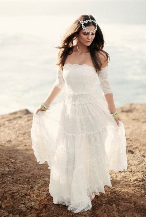 a boho lace off the shoulder wedding dress with short sleeves and a tiered ruffle skirt for a boho beach bride