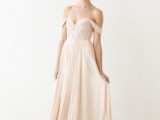 a blush off the shoulder A-line wedding dress with a draped bodice and a pleated skirt plus a small train is a refined and chic idea for a delicate and subtle wedding