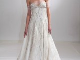 an embellished A-line off the shoulder wedding dress with a depe neckline and an embellished sheer detail on the neckline is wow