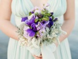 a mint colored bridesmaid dress with thick straps and a beautiful purple and pale greenery bouquet is a beautiful combo