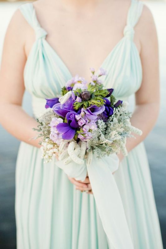 A mint colored bridesmaid dress with thick straps and a beautiful purple and pale greenery bouquet is a beautiful combo