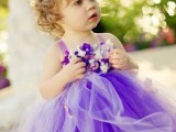 a purple flower girl dress of tulle and with a floral bodice plus a purple floral crown is super cute and bright