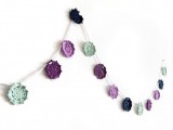 a purple, lavender and mint doily wedding garland is a nice decoration for a spring or summer wedding