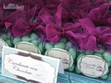 mint candies and purple bows on top in sheer boxes are nice wedding favors that you can DIY