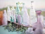 mint, lavender and purple mismatching bottles as wedding decor, they can be also used for creating centerpieces