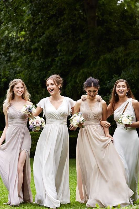 Mismatching blush and creamy maxi bridesmaid dresses with draperies, cutouts and ruffles are a very dreamy and chic idea to rock