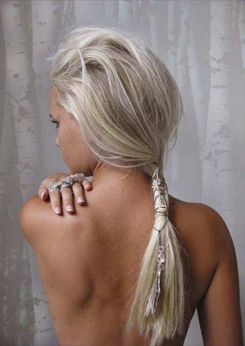 a creative messy beach hairstyle - a messy top and a low ponytail with a wrap and some rhinestones and chains is amazing