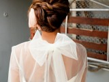 a dark woven low updo is a sleek and tight idea for a modern beach bride and it will keep you picture-perfect all day long