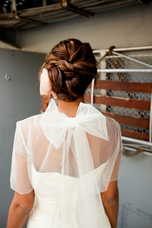 a dark woven low updo is a sleek and tight idea for a modern beach bride and it will keep you picture-perfect all day long