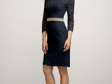 a black lace over the knee dress with a high neckline, long sleeves and a nude sash plus nude shoes for a refined and chic look