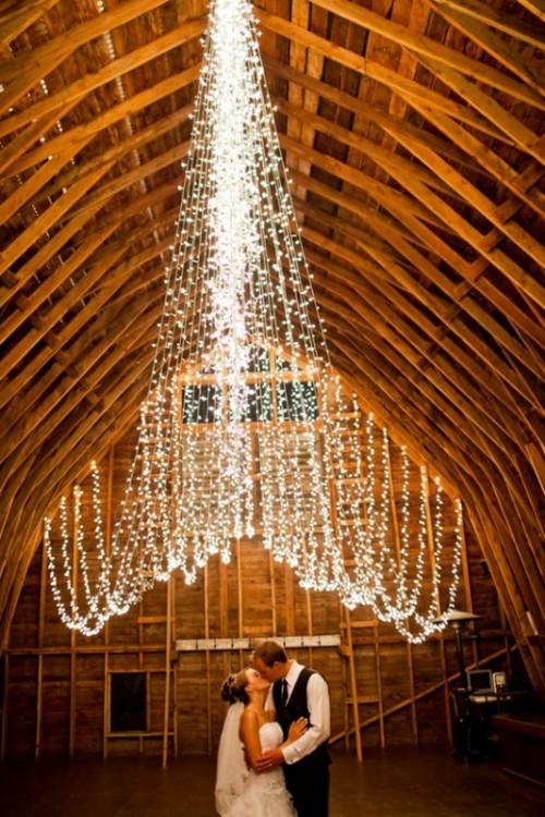 a creative wedding lights canopy going over the space is a lovely and beautiful idea to light up your space