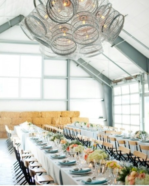 a white chandelier of cages is a whisical idea with a vintage feel and it looks very unusual and bold