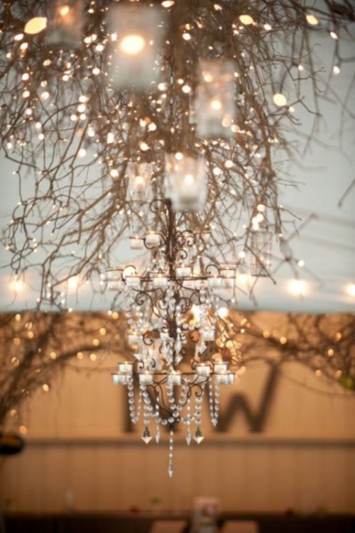 lit up branches and crystal and candle vintage chandeliers are a whimsical lighting up combo