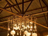 a whimsical chandelier with lots of various bulbs is a cool decoration and a lighting piece for a rustic venue