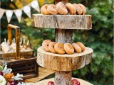 a large rustic dessert display of a tree trunk and thick wood slices is an easy and very statement-like idea for a rustic wedding
