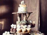 a rustic sweets display of wood slices, large and thick branches and tree stumps is a cool idea for a rustic or woodland wedding