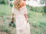 a relaxed boho wedding dress with an off the shoulder neckline, a lace bodice, a plain skirt with a lace trim