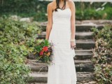 a strapless boho lace sheath wedding dress with a layered skirt and a floral crown for a chic look